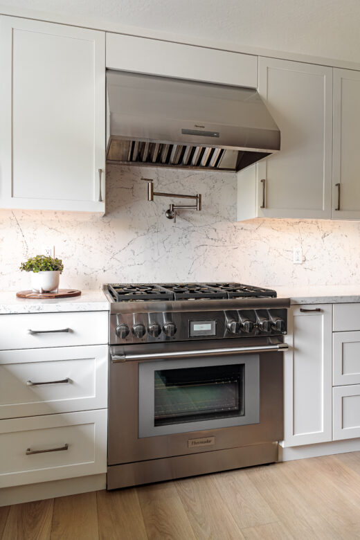 Thermador hood, gas range, white painted cabinets kitchen remodel