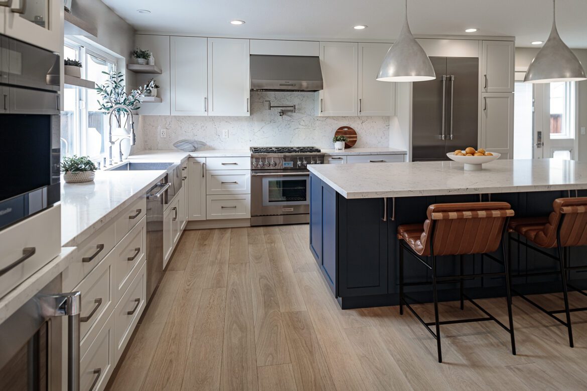 european oak floors, white shaker cabinets white quartz countertops and backsplash