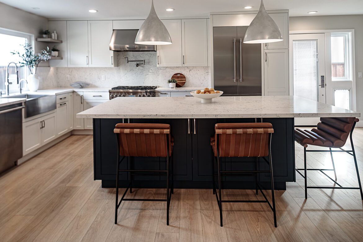 large blue island, white quartz countertop, silver pendants