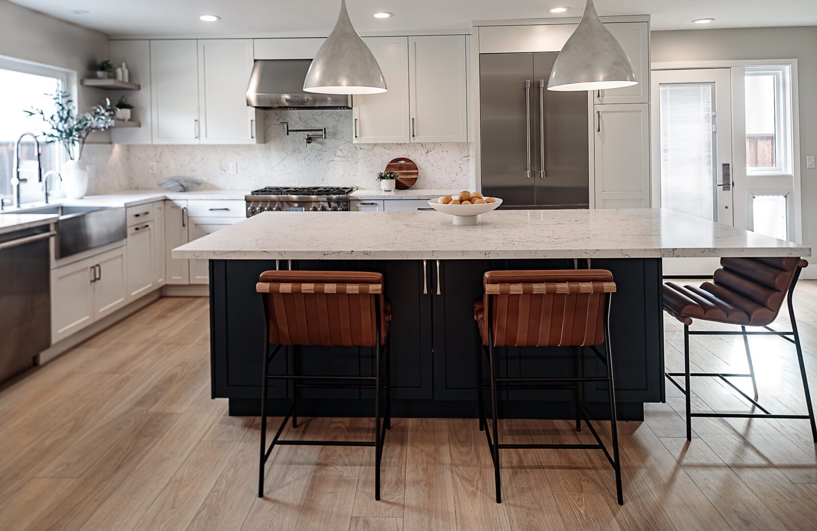 large blue island, white quartz countertop, silver pendants